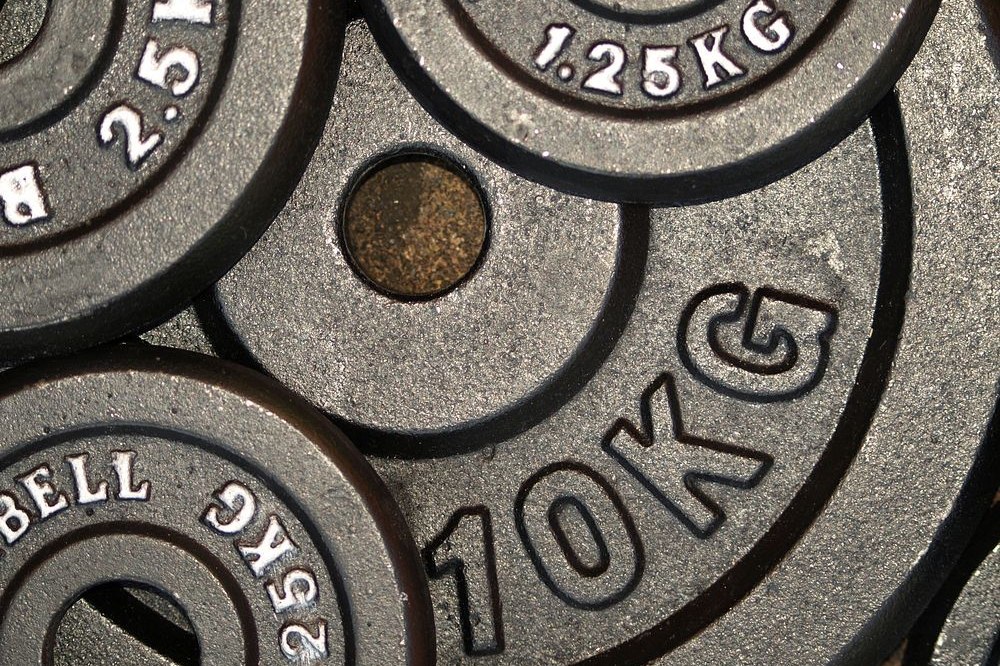 Overhead view of cast iron weight plates with 10KG, 2.5KG and 1.25KG cast into the metal