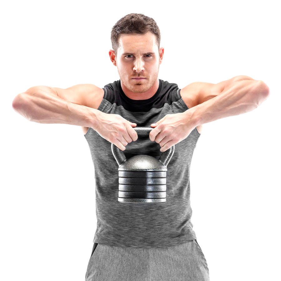 A lifter performing an upright row with a cast-iron adjustable kettlebell built from a stack of standard plates