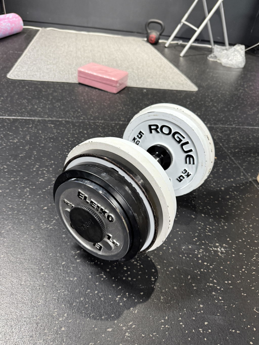 Adjustable handle loaded with white bumper plates