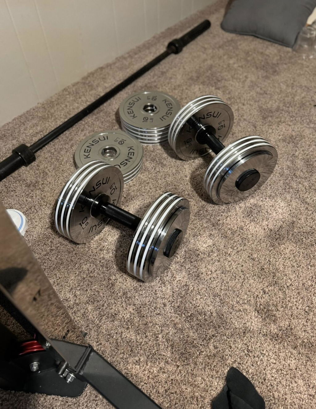 A pair of adjustable dumbbells loaded with chrome plates