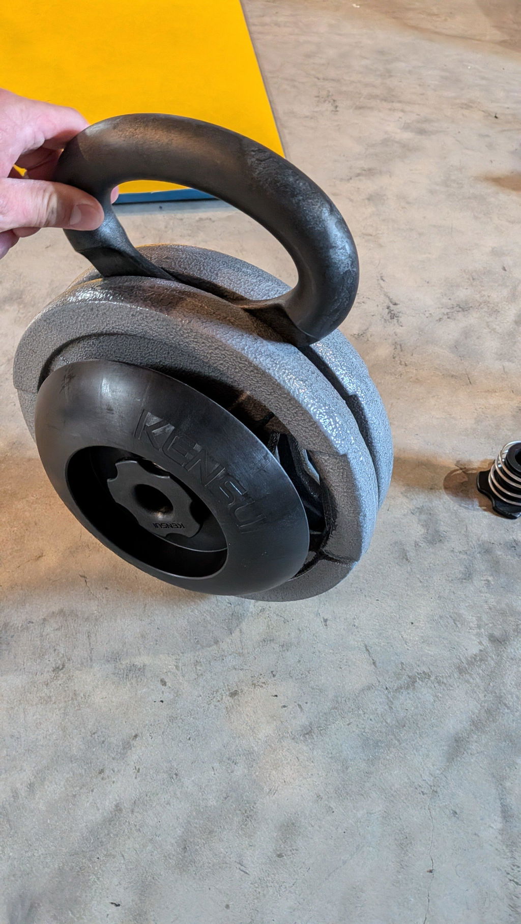 An owner holding a loaded EZ-BELL by the handle