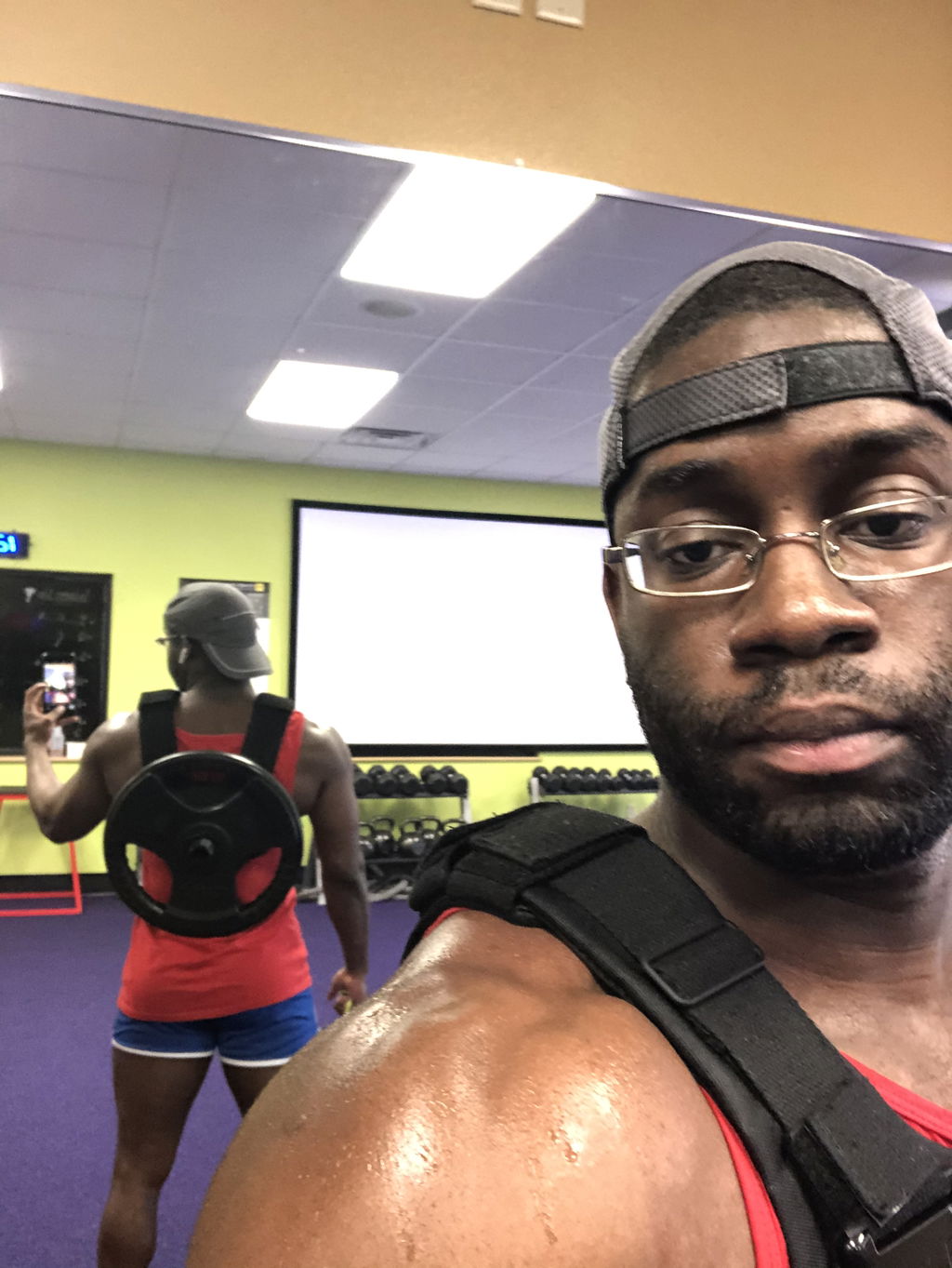 Sweat-soaked training shirt under a weight vest after a session