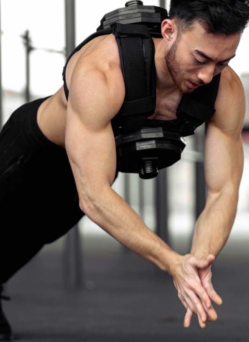 Remy Mock doing an explosive push-up wearing the plate-loaded vest he designed