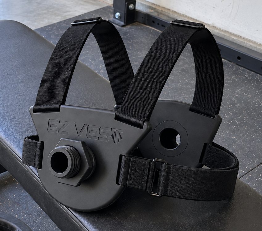 The EZ-VEST Lite strap vest lying on a weight bench in a garage