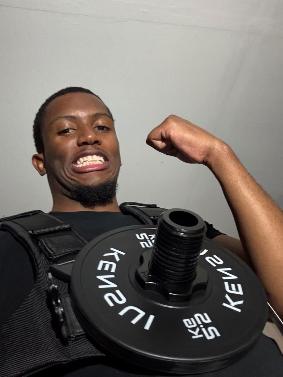 An owner flexing in the padded EZ-VEST with a black plate on the chest post